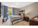 Bedroom featuring blue and white bedding, wood nightstand, and a window at 338 Elgin Dr, Lawrenceville, GA 30045