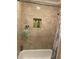 Clean bathroom with a shower/tub and tiled walls at 1189 Ashborough Se Dr # J, Marietta, GA 30067