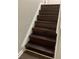 Dark brown stairs adding a touch of elegance to the home at 1189 Ashborough Se Dr # J, Marietta, GA 30067