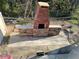 Brick outdoor fireplace and patio area at 1189 Ashborough Se Dr # J, Marietta, GA 30067
