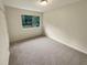 Well-lit bedroom with neutral walls and carpet at 1472 Pine Log Ne Rd, Conyers, GA 30012