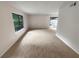 Large living room with neutral carpet and sliding doors at 1472 Pine Log Ne Rd, Conyers, GA 30012