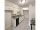 Bright kitchen with white cabinets, gray countertops, and black appliances at 1472 Pine Log Ne Rd, Conyers, GA 30012