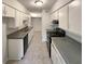 Galley kitchen with white cabinets, gray countertops, and black appliances at 1472 Pine Log Ne Rd, Conyers, GA 30012