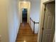 Long hallway with hardwood floors and access to bedrooms at 265 Regal Dr, Lawrenceville, GA 30046
