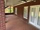 Brick patio with ceiling fan, access to backyard, and French doors at 265 Regal Dr, Lawrenceville, GA 30046
