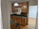 Wet bar with wood cabinets and granite countertop at 265 Regal Dr, Lawrenceville, GA 30046