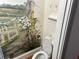 Small powder room with toilet and whimsical floral wall mural at 265 Regal Dr, Lawrenceville, GA 30046