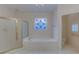 Relaxing bathroom with soaking tub, stained glass window, and separate shower at 265 Regal Dr, Lawrenceville, GA 30046