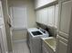 Laundry room with washer, dryer, cabinets, and sink at 265 Regal Dr, Lawrenceville, GA 30046