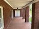 Brick porch with columns, ceiling fan and access to backyard at 265 Regal Dr, Lawrenceville, GA 30046