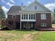 Two-story brick house with a large deck and backyard at 265 Regal Dr, Lawrenceville, GA 30046