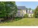 Beautiful two-story house with a manicured lawn and mature trees at 1357 Baniff Ct, Snellville, GA 30078