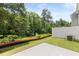 Private backyard with a spacious patio and wooded backdrop at 348 Elgin Dr # 162, Lawrenceville, GA 30045