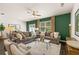 Spacious living room with green accent wall and comfortable seating at 348 Elgin Dr # 162, Lawrenceville, GA 30045