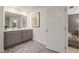 Double vanity bathroom with gray cabinets and a view into bedroom at 348 Elgin Dr # 162, Lawrenceville, GA 30045