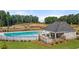 Community swimming pool with a pool house and surrounding landscaping at 348 Elgin Dr # 162, Lawrenceville, GA 30045