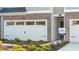 Townhouse garage with white door, stone accents, and landscaping at 348 Elgin Dr # 162, Lawrenceville, GA 30045