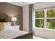 Bedroom with a queen-size bed and large window with tree views at 348 Elgin Dr # 162, Lawrenceville, GA 30045