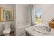 Clean bathroom featuring a bathtub, double vanity, and a tranquil view at 348 Elgin Dr # 162, Lawrenceville, GA 30045