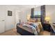 Bedroom with full bed, navy blue headboard, and access to bath at 328 Elgin Dr, Lawrenceville, GA 30045