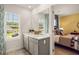 Bathroom with double vanity, gray cabinets, and a view to bedroom at 328 Elgin Dr, Lawrenceville, GA 30045