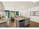 Open kitchen with island, stainless steel appliances and view into living room at 328 Elgin Dr, Lawrenceville, GA 30045