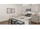 Bright kitchen with granite island, stainless steel appliances, and gray cabinets at 328 Elgin Dr, Lawrenceville, GA 30045
