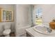 Bathroom with bathtub, double vanity, and a window with a view at 328 Elgin Dr, Lawrenceville, GA 30045