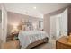Bedroom with queen bed, ensuite bath access, and soft pink walls at 328 Elgin Dr, Lawrenceville, GA 30045