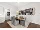 Bright dining room with hardwood floors and modern light fixture at 3739 Tielman St, Snellville, GA 30078