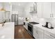 Modern kitchen with stainless steel appliances and white shaker cabinets at 3739 Tielman St, Snellville, GA 30078