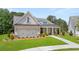 Craftsman style home with brick facade, metal roof, and two-car garage at 3739 Tielman St, Snellville, GA 30078