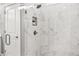 Large walk-in shower with marble tile and built-in shelf at 3739 Tielman St, Snellville, GA 30078