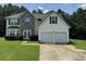 Two-story house with a two-car garage and stone accents at 2112 Bradford Pear Se Cir, Conyers, GA 30013