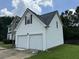 Two-car garage with white vinyl siding at 2112 Bradford Pear Se Cir, Conyers, GA 30013