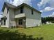 Two-story house with vinyl siding, large backyard, and partial view of street at 2112 Bradford Pear Se Cir, Conyers, GA 30013