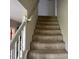 Carpeted staircase with white railing at 2112 Bradford Pear Se Cir, Conyers, GA 30013