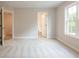 Bedroom with carpet, neutral walls, and access to bathroom at 1956 Deco Dr, Kennesaw, GA 30144