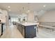 Open concept kitchen with large island, stainless steel appliances, and white shaker cabinets at 1956 Deco Dr, Kennesaw, GA 30144