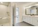 Elegant bathroom with double vanity, large mirror, and walk-in shower at 1956 Deco Dr, Kennesaw, GA 30144