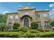 Elegant two-story brick home with ornate entryway and manicured landscaping at 1197 Lynmoor Ne Dr, Brookhaven, GA 30319