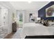 Bright bedroom with a king-size bed, a navy accent wall, and a window view at 3869 Tielman St, Snellville, GA 30078