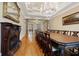 Formal dining room with long table, hardwood floors, and fireplace at 1197 Lynmoor Ne Dr, Brookhaven, GA 30319