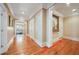 Long hardwood hallway with access to other rooms and a grand staircase at 1197 Lynmoor Ne Dr, Brookhaven, GA 30319