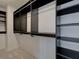 Large walk-in closet with custom shelving and hanging rods at 1996 Deco Dr, Kennesaw, GA 30144