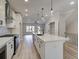 Open concept kitchen with island, white cabinets and hardwood floors at 1996 Deco Dr, Kennesaw, GA 30144