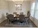 Bright dining room features wood flooring and wainscoting at 221 Eleanora Way, Loganville, GA 30052