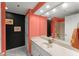 Bathroom with coral walls, white vanity, and marble bathtub at 3435 Kingsboro Ne Rd # 1201, Atlanta, GA 30326