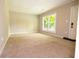 Bright and airy living room with neutral carpet and large windows at 6626 Dorian Dr, Union City, GA 30291